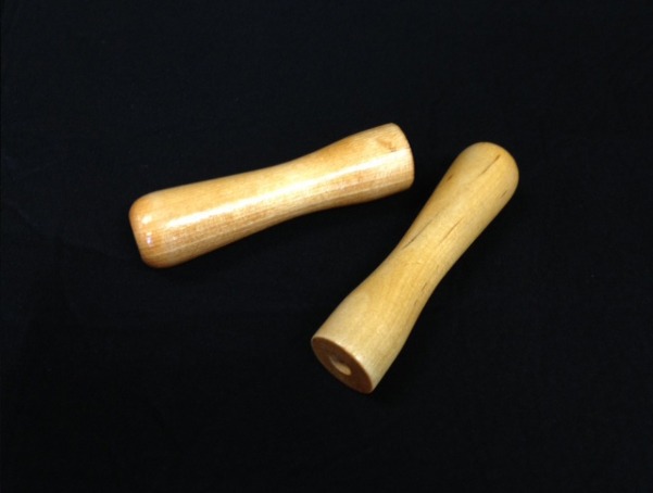 Two small custom wooden handles with a single drilled hole on one end for easy attachment in manufacturing applications.